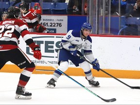 Alex Assadourian, right, of the Sudbury Wolves, attempts to skate past Matthew Mayich, of the Ottawa 67's, during OHL action at the Sudbury Community Arena in Sudbury, Ont. on Friday November 19, 2021. John Lappa/Sudbury Star/Postmedia Network