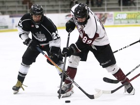 Chatham Maroons' David Brown (89) battles Komoka Kings' Eduard Jaansoo (23) for the puck in the third period at Chatham Memorial Arena in Chatham, Ont., on Tuesday, April 5, 2022. Mark Malone/Chatham Daily News/Postmedia Network