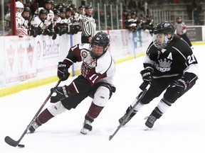 Chatham Maroons' Dylan Glinski (11) is chased by Komoka Kings' Will K. Lewis (21) at Chatham Memorial Arena in Chatham, Ont., on Sunday, April 10, 2022. Mark Malone/Chatham Daily News/Postmedia Network