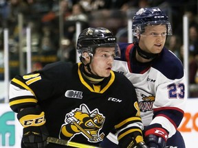 Sarnia Sting's Max Namestnikov, left, battles Saginaw Spirit's Pacey Schlueting in the first period at Progressive Auto Sales Arena in Sarnia, Ont., on Friday, April 15, 2022. Mark Malone/Chatham Daily News/Postmedia Network