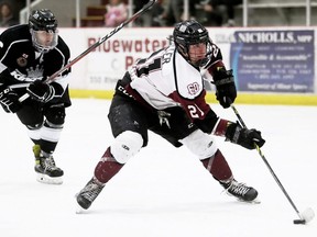 Chatham Maroons' Nolan Miller is pursued by Komoka Kings' Darius Mani on a breakaway in the second period at Chatham Memorial Arena in Chatham, Ont., on Friday, April 15, 2022. Mark Malone/Chatham Daily News/Postmedia Network