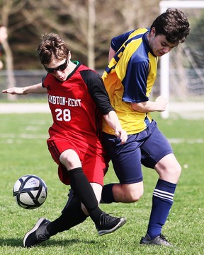 Lambton-Kent Cardinals' Marty Elliott (28) and Pain Court Patriotes' George Ansell battle in the first half of an LKSSAA senior boys' soccer game at Ecole Secondaire de Pain Court in Pain Court, Ont., On Thursday, April 28, 2022 Mark Malone / Chatham Daily News / Postmedia Network