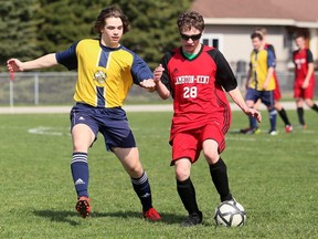 Lambton-Kent Cardinals' Marty Elliott (28) and Pain Court Patriotes' Travis Caron battle in the first half of an LKSSAA senior boys' soccer game at Ecole Secondaire de Pain Court in Pain Court, Ont., on Thursday, April 28, 2022. Mark Malone/Chatham Daily News/Postmedia Network