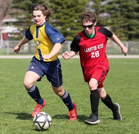 Lambton-Kent Cardinals' Marty Elliott (28) and Pain Court Patriotes' Travis Caron battle in the first half of an LKSSAA senior boys' soccer game at Ecole Secondaire de Pain Court in Pain Court, Ont., On Thursday, April 28, 2022 Mark Malone / Chatham Daily News / Postmedia Network