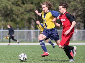 Pain Court Patriotes' Carson May, left, and Lambton-Kent Cardinals' Konnor Smith battle in the first half of an LKSSAA senior boys' soccer game at Ecole Secondaire de Pain Court in Pain Court, Ont., On Thursday, April 28, 2022 Mark Malone / Chatham Daily News / Postmedia Network