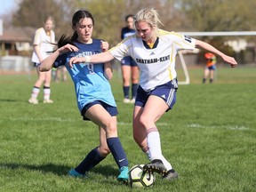 Ursuline Lancers' Elenna Abreu, left, and Chatham-Kent Golden Hawks' Julia Trinca battle for the ball in the second half of an LKSSAA senior girls' soccer game at the Chatham-Kent Community Athletic Complex in Chatham, Ont., on Friday, April 29, 2022. Mark Malone/Chatham Daily News/Postmedia Network
