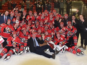 Members of the 2021-22 Mitchell Hawks, winners of the Provincial Junior Hockey League (PJHL) Pollock Division, celebrate their 8-0 victory in Game 7 which gave them their first-ever title after 14 years in the Junior C league. Back row (left): Rev. Will Kramer, chaplain; Andy Louwagie, past president; Ben Nelson, assistant coach; Holdyn Lansink, assistant coach; Braeden Burdett, Connor Lockhart, affiliate player; Logan Broughton on shoulders of dad Cory Broughton, president; Jason Baier, director of player personnel; Callan Ferguson, Aiden McMann, Caleb Musselman, Seth Huygen, Callum McMann, Sean Chisholm, Josh Keil, general manager; Ryan Duck, equipment manager; Ken Jacklin, assistant coach; Kristen Louwagie, athletic therapist. Second row (left): Bradley Boville, Jared LeSouder, Zach McCann, affiliate player; Patrick Holloway, Zach Dow, Ryan Murray, Carter Musselman, Mark Cassidy, Nolan Gagnier, Brent Krahn, Jameson Mitchell. Front row (left): Carter Lewis, Charlie Rankin, Tyson Hall, Louie Livingston, head coach; Malcolm McLeod, Tyler Parr and Evan Dowd. ANDY BADER/MITCHELL ADVOCATE