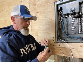 Shawn Poole, electrical technician at Postma Heating and Cooling, completing some in-house wiring that will support in-office expansion at Postma headquarters, on Charing Cross Road. SUPPLIED