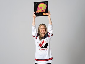 Jayna Hefford sports the sweater and record signed by The Tragically Hip that are up for auction in support of the "Keep Her in Play" initiative.