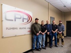 Mayor Bob Young is flanked by representatives of Leduc Plumbing and Heating in the LPH Boardroom at the Leduc Recreation Centre. (City of Leduc)