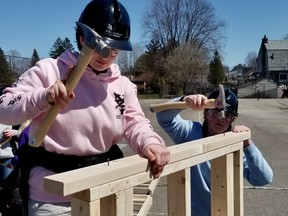 Isla Adams, 16, and Keira Wrigley, 17, build a wall in the Skills Ontario Competition at OSDSS Friday, April 22, 2022 in Owen Sound, Ont. (Scott Dunn/The Sun Times/Postmedia Network)
