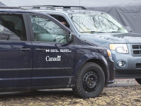 Canada Food Inspection Agency vehicles sit outside of a turkey farm on Highway 2 in Oxford County following an outbreak of bird flu in 2015. (London Free Press file photo)