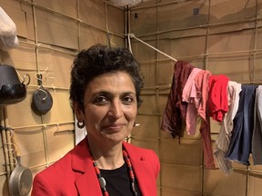 Reena Kukreja stands in front of what would be a typical South Asian migrant worker's camp in Greece as part of her new exhibit, "This is Evidence." The multimedia exhibit opened Monday inside the Art and Media Lab at the Isabel Bader Centre for the Performing Arts.