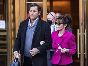 Sarah Palin departs with former NHL player Ron Duguay during her defamation lawsuit against the New York Times, at the United States Courthouse in the Manhattan borough of New York City, Wednesday, Feb. 9, 2022.