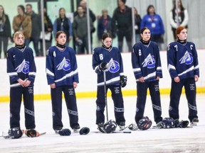 Marea Moman (from left to right), Karley Clark, Madison Rice, Kiara McAvena and Tessa Galandy stand during the national anthem before one of their games during the Canadian Ringette Championships. The Zone 2 Blaze, playing as Team Alberta, went undefeated, winning gold and becoming national champions. Photo courtesy of the Canadain Ringette Championship (CRC).