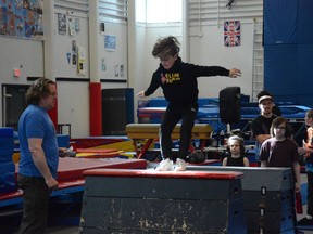 A boy puts his agility to the test, jumping from one beam to the next and landing on both feet during Airdrie Edge Gymnastic's first ever parkour competition on April 10. Photo by Riley Cassidy/The Airdrie Echo/Postmedia Network Inc.