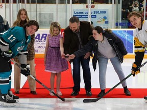 Loyalist College student Wayne Hunter, who organized a fundraiser for the Community Development Council of Quinte's We All Deserve To Eat campaign and food for the Trenton Care and Share Food Bank, participates in a ceremonial puck drop at at Trenton Golden Hawks game. SUBMITTED PHOTO