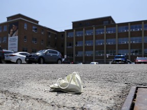 A discarded mask lies in the parking lot of Belleville General Hospital June 10, 2020. Regional health officials are calling upon residents to taking greater precautions to help lessen the sixth wave's effect on patients and the health sector.