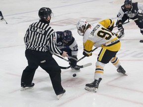 Trenton Golden Hawk Aaron Jamieson battles during a faceoff with Haliburton CountyÕs Patrick Saini during second-period action Sunday afternoon. Trenton skated to a 5-2 win in the opening game of the best-of-three East Division semi-final. BRUCE BELL