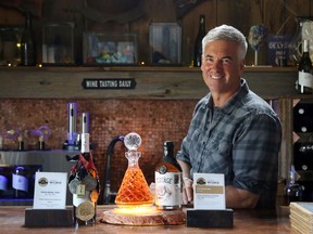 Potter Settlement Artisan Winery owner and winemaker Sandor Johnson displays the winery's award-winning Cabernet Franc and Portage fortified wine at the winery northeast of Tweed. International awards are raising the winery's profile amid plans to expand while remaining an artisanal operation.