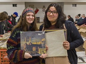 Cassidy Sinclair (left), 16, of Paris and 17-year-old Emily Rushton of Brantford show some of the vinyl records they purchased on Sunday at the Brantford Record Show.