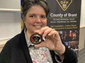 Jennifer Haley, chair of the County of Brant Police Services Board, holds a Brant County OPP Challenge Coin. The coin will be presented to individuals to recognize a special achievement and to those who go above and beyond the call of duty to provide assistance to a person in need in the County of Brant. VINCENT BALL