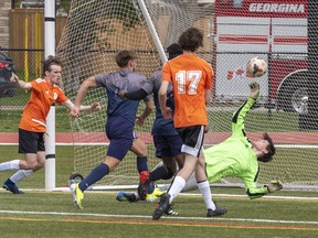 North Park Trojans goalkeeper Ethan Sinclair initially keeps the ball out of the net, but Assumption's Forbes Nyakarombo scored on the rebound during a high school boys soccer game on Monday in Brantford.