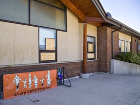Windows remain boarded up at Lloyd S. King elementary school on Thursday at Mississaugas of the Credit First Nation. Vandals smashed doors, windows and spray-painted graffiti overnight on Monday forcing officials to close the school until May 2 to carry out clean up and repairs.
