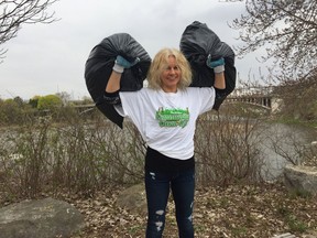 Tracey Bucci, who died last month at age 50, is shown collecting garbage along the banks of the Grand River. The city plans a permanent memorial to Bucci, who was president for nearly 20 years of the Grand River Environmental Group. Expositor file photo