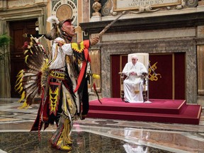 A member of Canada's Indigenous delegation chants and dances before Pope Francis during an audience at the Vatican on Friday.  VATICAN MEDIA