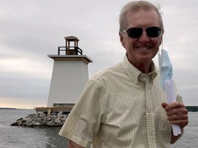 Former senator Bob Runciman stands on a boat as it passes by his recent fundraising cause, the Five Mile Light replica, in September, 2020. (FILE PHOTO)