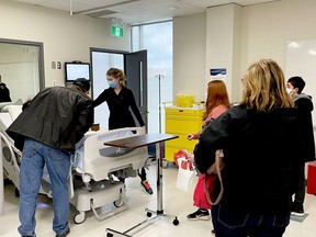 Part-time nurse instructor Hailey McDonald gives visitors a tour of the nursing lab at St. Lawrence College in Brockville during their first open house in over two years on Saturday. (MARSHALL HEALEY/The Recorder and Times)