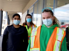From left, Simerjot Bains, administrative liaison, and intake clinical runners Lisa MacInnis and Chloe Nash pose outside the COVID-19 clinical assessment centre in Brockville on Friday morning. (RONALD ZAJAC/The Recorder and Times)