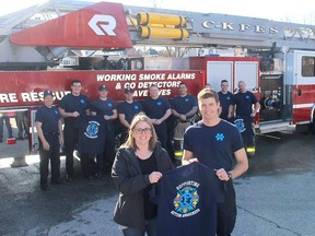 Members of the Chatham-Kent Professional Firefighters Association are marking Autism Month by holding an in-house fundraiser to support a new Entry to School Program through the Children's Treatment Centre of Chatham-Kent to help kids with autism, aged three to six, transition into school. Lisa Caron, fund development officer with the Children's Treatment Centre Foundation, is seen here with Chatham firefighter Steve Amlin and other firefighters with Station No. 1 Chatham, displaying T-shirts that have been made to mark Autism Month. Ellwood Shreve/Postmedia