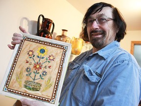 Chatham artist Bernie Hrytzak holds up a book cover he designed for a Ukrainian cultural museum in Saskatoon. He will present it at ARTspacce in Chatham on April 7 before he delivers it to the museum.