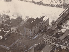 The Bank of Montreal can be seen just to the right of the Grand Opera House which is the very large white building towards the left of the photo. Fifth Street Bridge at far right. Photo looks northwest.