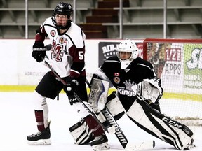 Chatham Maroons' Cameron Welch, left, tries to screen Komoka Kings goalie Omar Hage at Chatham Memorial Arena in Chatham, Ont., on Sunday, Nov. 14, 2021. Mark Malone/Chatham Daily News/Postmedia Network