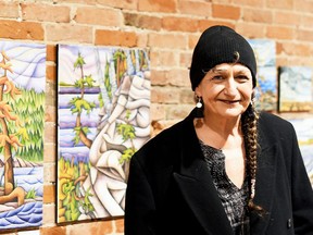 Chatham artist Tracy Root is shown next to paintings from Prism of Perception, her exhibition at ARTspace in downtown Chatham. PHOTO Tom Morrison/Postmedia