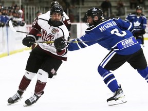 Chatham Maroons' Owen Sculthorp, left, eludes a check by London Nationals ' Owen McGowan in the second period at Chatham Memorial Arena in Chatham, Ont., on Friday, April 22, 2022. Mark Malone/Chatham Daily News/Postmedia Network)