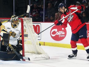 Sarnia Sting goalie Ben Gaudreau keeps an eye on Windsor Spitfires' Wyatt Johnston in Game 1 of their OHL Western Conference quarter-final at the WFCU Centre in Windsor, Ont., on Thursday, April 21, 2022. (Dan Janisse/Windsor Star)