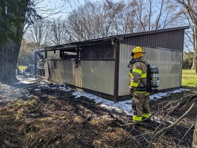 A garage, along with a classic car and motorcycle inside, were destroyed when fire from brush being burned on a Zone Road 5 property Friday afternoon spread, causing an estimated $100,000 damage. (Handout Photo)