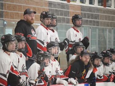 Eastern Warriors players, along with coaches Cameron Muir (top row) and Thomas St. Pierre, look on during a Friday battle of unbeaten squads at the juvenile broomball nationals. Photo on Friday, April 15, 2022, in Cornwall, Ont. Todd Hambleton/Cornwall Standard-Freeholder/Postmedia Network