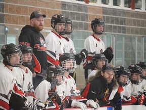 Eastern Warriors players, along with coaches Cameron Muir (top row) and Thomas St. Pierre, looking on during action against the Blitz Temiscouata at the juvenile broomball nationals. The Blitz on Saturday beat the Warriors 3-0 in the gold medal game.Photo in Cornwall, Ont. Todd Hambleton/Cornwall Standard-Freeholder/Postmedia Network