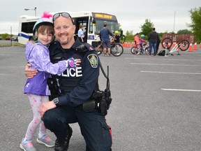 Youth Outreach Officer, Const. Casey MacGregor, pictured right with a youth at CPS Bikes & Badges event held in 2019. Handout/Cornwall Standard-Freeholder/Postmedia Network
