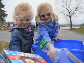 From left, Quinn and Grace Scheffer doing their part for our planet, recycling at Eco Day on Saturday April 23, 2022 in Cornwall, Ont. Shawna O'Neill/Cornwall Standard-Freeholder/Postmedia Network