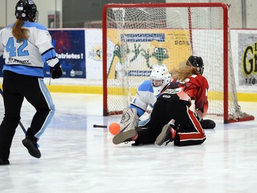 A Seaway Devils player on her knees, watching Palmerston Terminator goaltender Chantel Embro prepping for the save during 2022 Broomball Canada Juvenile National Championships play on Wednesday April 13, 2022 in Cornwall, Ont. The Devils won 2-0. Robert Lefebvre/Special to the Cornwall Standard-Freeholder/Postmedia Network