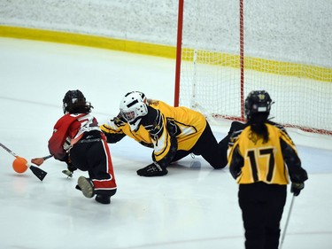 A Seaway Devils player tries to get her stick on the ball at the same time as Team Manitoba goaltender Hannah Funk in Broomball Canada National Juvenile Championship play on Thursday April 14, 2022 in Cornwall, Ont. The Devils won 6-0. Robert Lefebvre/Special to the Cornwall Standard-Freeholder/Postmedia Network