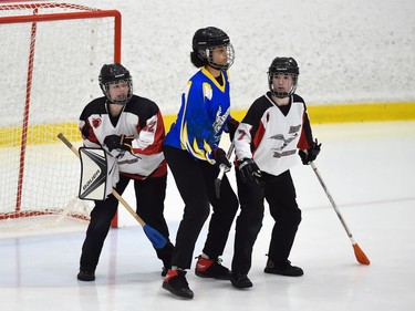 Debden Roadrunners goaltender Ayla Peterson (left) and Gracie Cyr sandwich a Blizzard player in Broomball Canada National Juvenile Championship play on Thursday April 14, 2022 in Cornwall, Ont. The Roadrunners won 4-0. Robert Lefebvre/Special to the Cornwall Standard-Freeholder/Postmedia Network