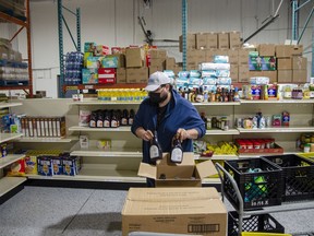 Benjamin Mailloux sorts food donations at the Wood Buffalo Food Bank, on Wednesday, September 8, 2021. Scott McLean/Fort McMurray Today/Postmedia Network