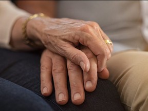 An elderly couple holding hands is pictured in a file photo.